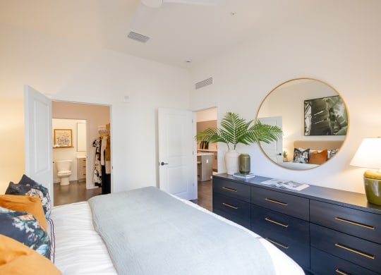 a bedroom with a bed and a dresser with a mirror  at La Unión, Tampa