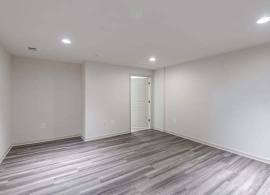 A room with a wooden floor and a white door at Garfield Park, Arlington, 22201