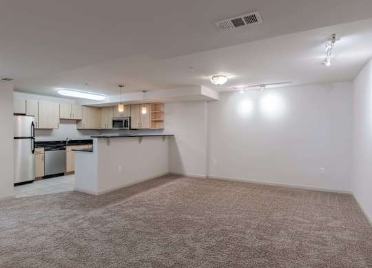 A spacious kitchen with white cabinets and stainless steel appliances at Garfield Park, Arlington, 22201
