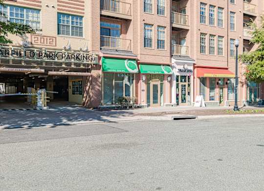 A parking garage is located in front of a building with a green awning at Garfield Park, Arlington, 22201