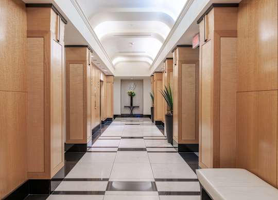 A long hallway with wooden doors and a checkered floor at Garfield Park, Arlington, 22201