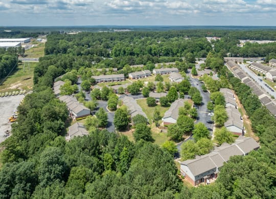 an aerial view of a neighborhood with houses and trees at Greens at Stonecreek, Lithonia, GA