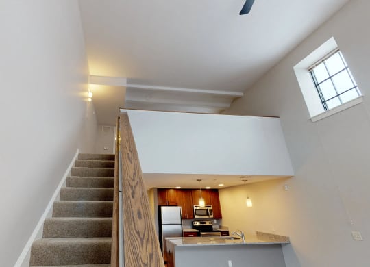 Room interior with wooden floor, staircase at The Gunther, Baltimore, MD, 21224