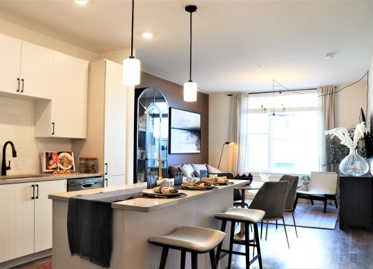 a kitchen with an island and stools in a 555 waverly unit at Vyne One Loudoun, Ashburn, 20147