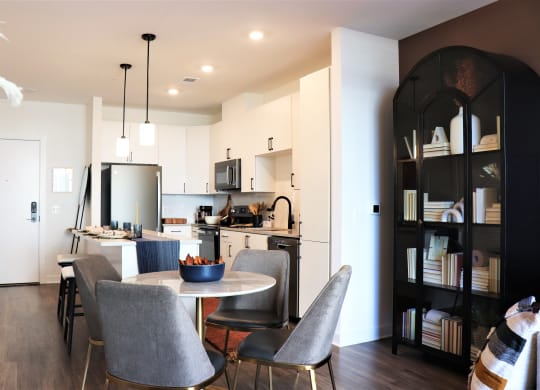 a kitchen and dining area in a 555 waverly unit at Vyne One Loudoun, Ashburn, Virginia