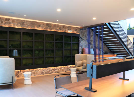a view of the lobby with a large black wall and a staircase with black metal railings at Vyne One Loudoun, Virginia