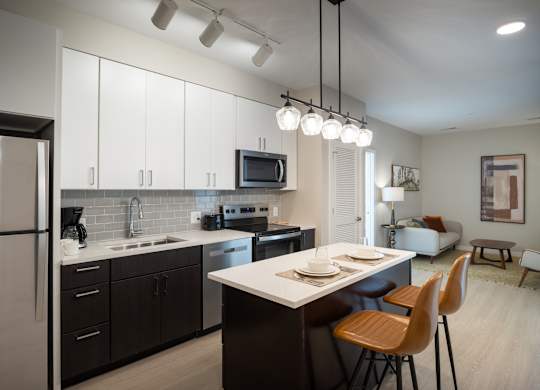 A modern kitchen with a dining table and chairs.