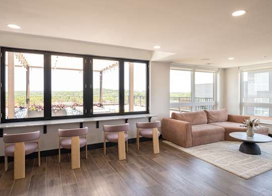 A living room with a couch, chairs, and a table.