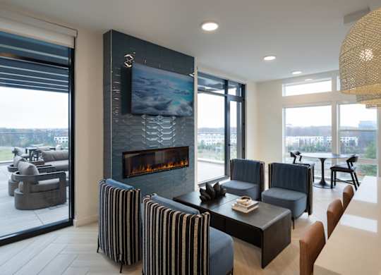 A modern living room with a fireplace and a television.