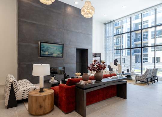 A modern living room with a fireplace and a large painting on the wall at The Sully Apartments, Chantilly, Virginia