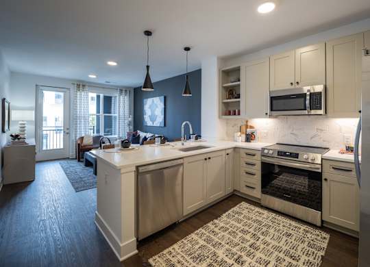 A kitchen with a large island and a refrigerator at The Sully Apartments, Virginia, 20151