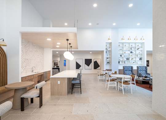 A modern dining area with a white and wood theme at The Sully Apartments, Chantilly, Virginia