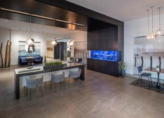 A modern living room with a large TV and a dining table with chairs. at Dock 79, Washington, DC 20003 
