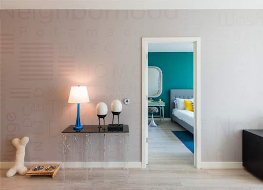 A lamp with a blue shade and two white spherical lamps on a table in a room. at Dock 79, Washington, DC 20003 