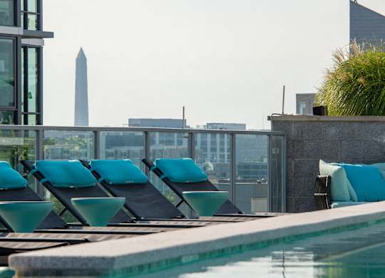 A pool with lounge chairs and a view of the Washington Monument in the distance. at Dock 79, District of Columbia
