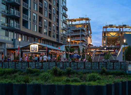 Salt restaurant with people sitting outside at dusk. at Dock 79, Washington, DC