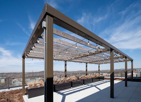 A modern pergola with wooden slats and metal frame.