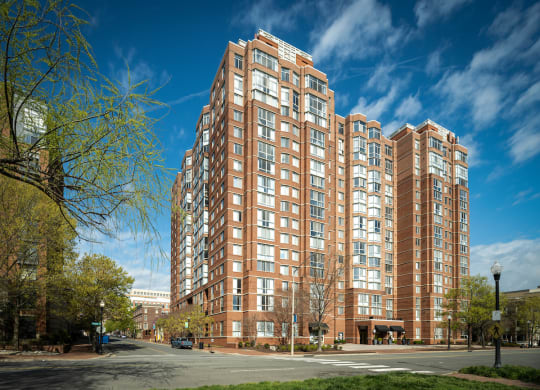 a large apartment building on the corner of a city street