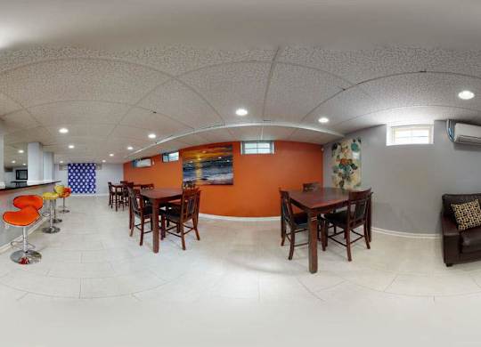 A white room with orange walls and furniture at Huntwood Courts Apartments, Washington, Washington DC