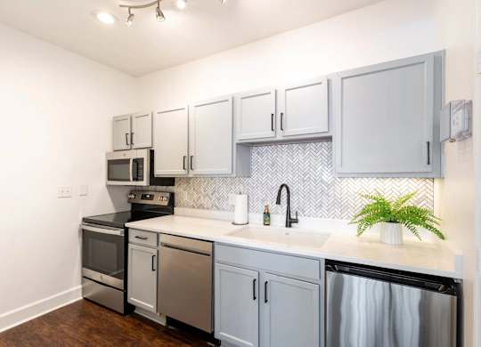 A kitchen with a black oven and a black dishwasher.at Crestline Cary, Cary North Carolina