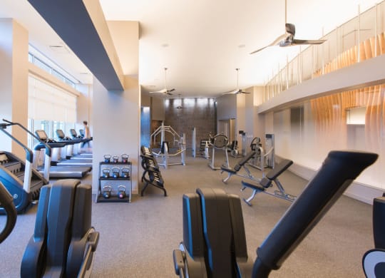 a room filled with lots of different types of exercise equipment at The Acadia at Metropolitan Park, Arlington