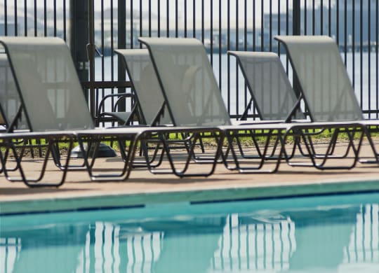 a group of lounge chairs next to a swimming pool at Tindeco Wharf, Baltimore, MD