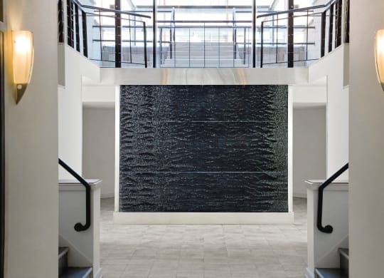 a large black water fountain in the middle of a building at Tindeco Wharf, Baltimore, MD