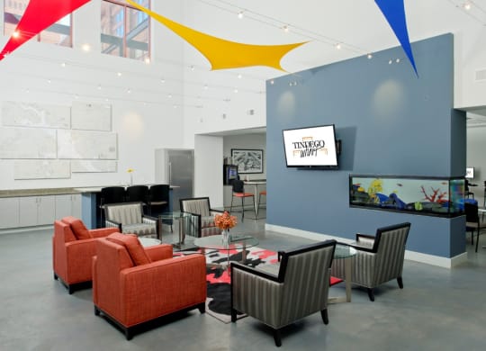 a conference room with orange chairs and a glass table and a wall with graphic design at Tindeco Wharf, Baltimore