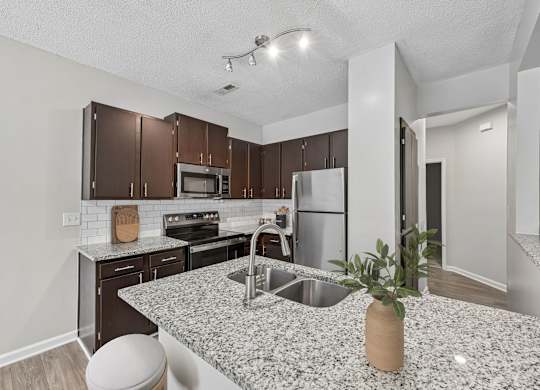 A kitchen with a granite countertop and a sink.