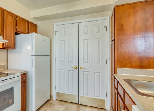 a kitchen with white appliances and wooden cabinets at North Market South Carroll, Maryland, 21701