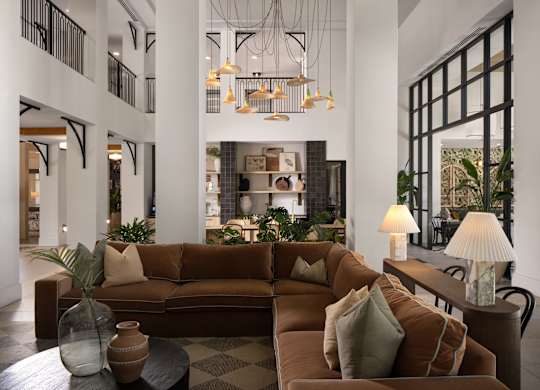 A living room with a brown couch and a coffee table.