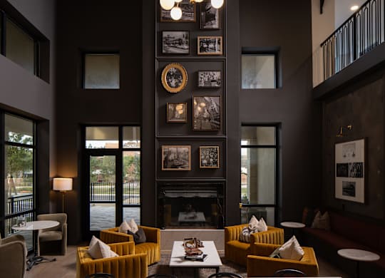A living room with a fireplace and a large chandelier.