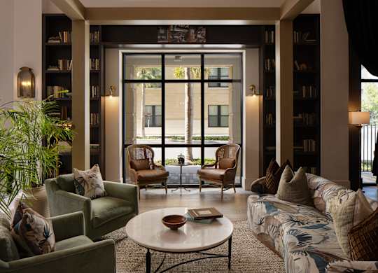 A living room with a couch, chairs, and a coffee table.