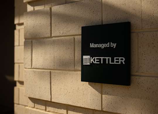 A sign on a wall that says "Managed by Kettler".