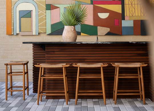 A bar with a large mural on the wall behind it.