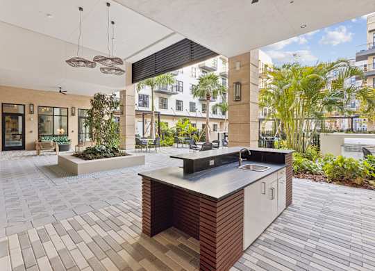 A modern kitchen with a large island and a view of the city.