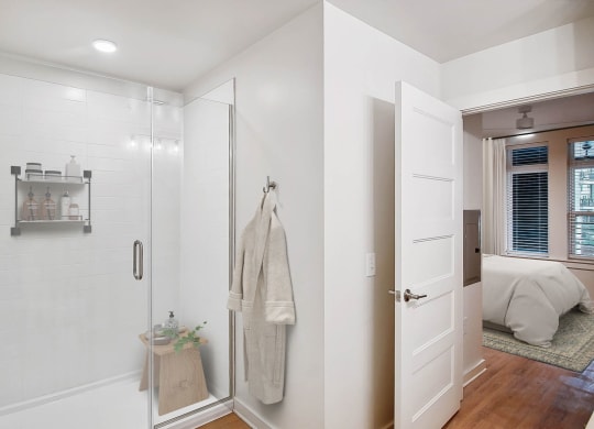 a white bathroom with a shower and a bed at Hawkins Press Apartments, Charlotte