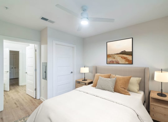a bedroom with a large bed and a ceiling fan at Hawkins Press Apartments, Charlotte