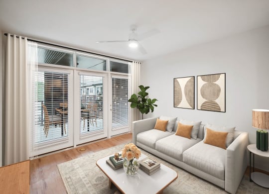 a living room with a couch and a coffee table and sliding glass doors at Hawkins Press Apartments, Charlotte