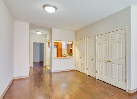 a renovated living room with white doors and a hallway to a bathroom at North Market South Carroll, Frederick