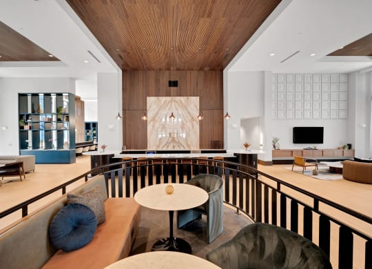 the lobby of a hotel with chairs and tables at Preston Ridge, Cary, 27513