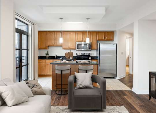 A modern kitchen with wooden cabinets and a refrigerator. at Loree Grand at Union Place, Washington, DC, 20002