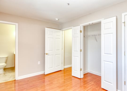 an empty bedroom with four closets and a toilet at North Market South Carroll, Frederick, MD