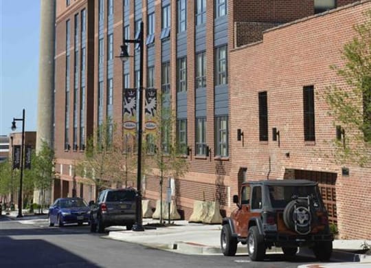 a large brick building with an old truck parked in front of it at The Gunther, Baltimore, 21224