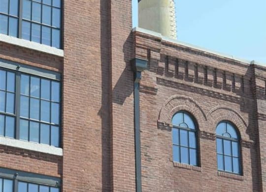 a tall brick building with a smoke stack on top of it at The Gunther, Baltimore, Maryland