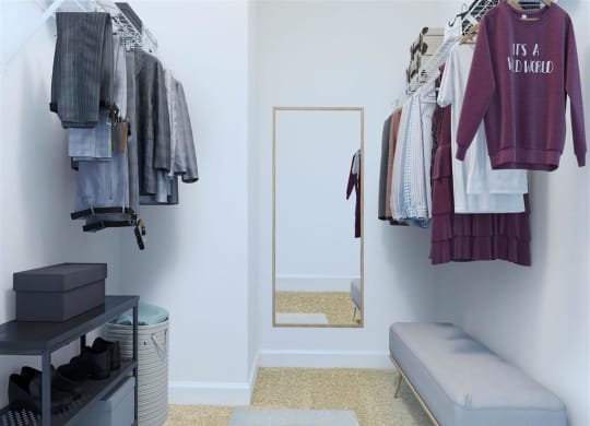 a small dressing room with a mirror and a bench at The Gramax, Silver Spring, MD, 20910