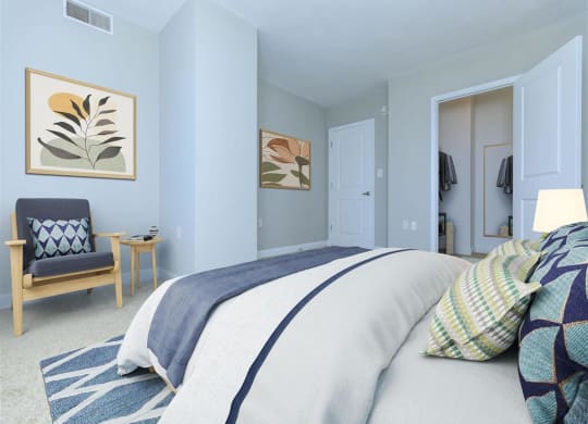 a bedroom with a bed and a chair in a room at The Gramax, Silver Spring, MD