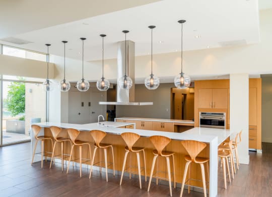 a large kitchen with an island and bar stools at The Acadia at Metropolitan Park, Arlington, Virginia