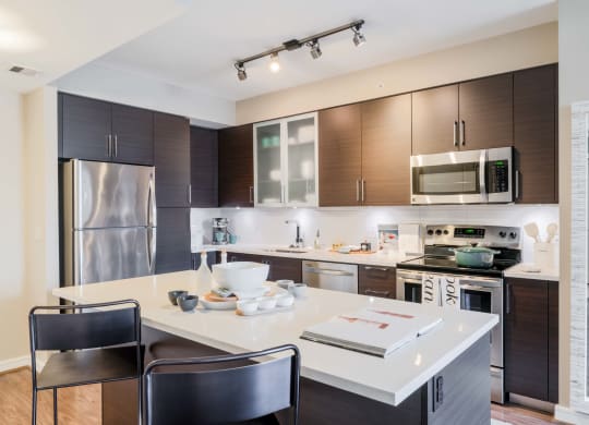 a kitchen with a large island and a stainless steel refrigerator at The Acadia at Metropolitan Park, Arlington, VA, 22202