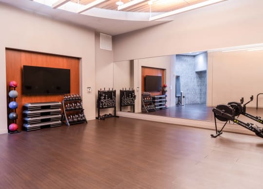 a large room with a drum set and a tv on the wall and a mirror at The Acadia at Metropolitan Park, Virginia